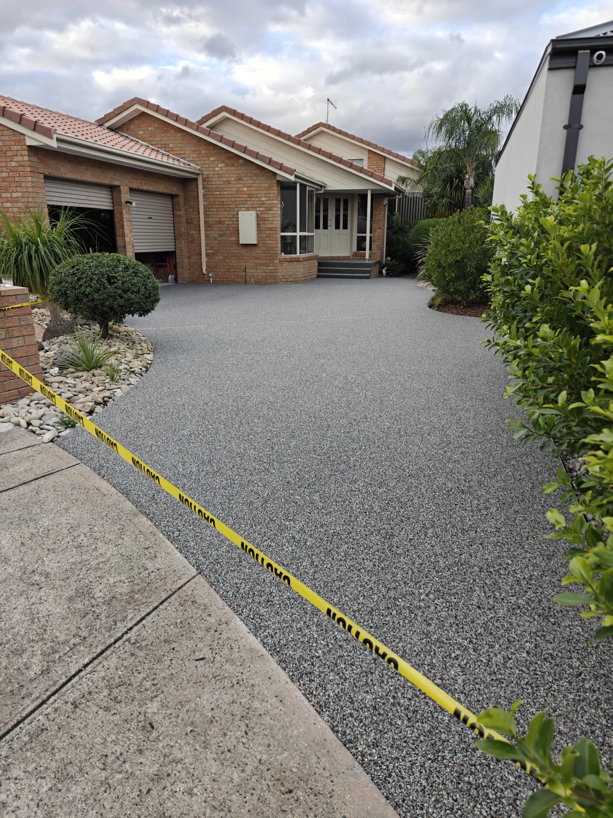 Completed light grey resin-bound stone driveway