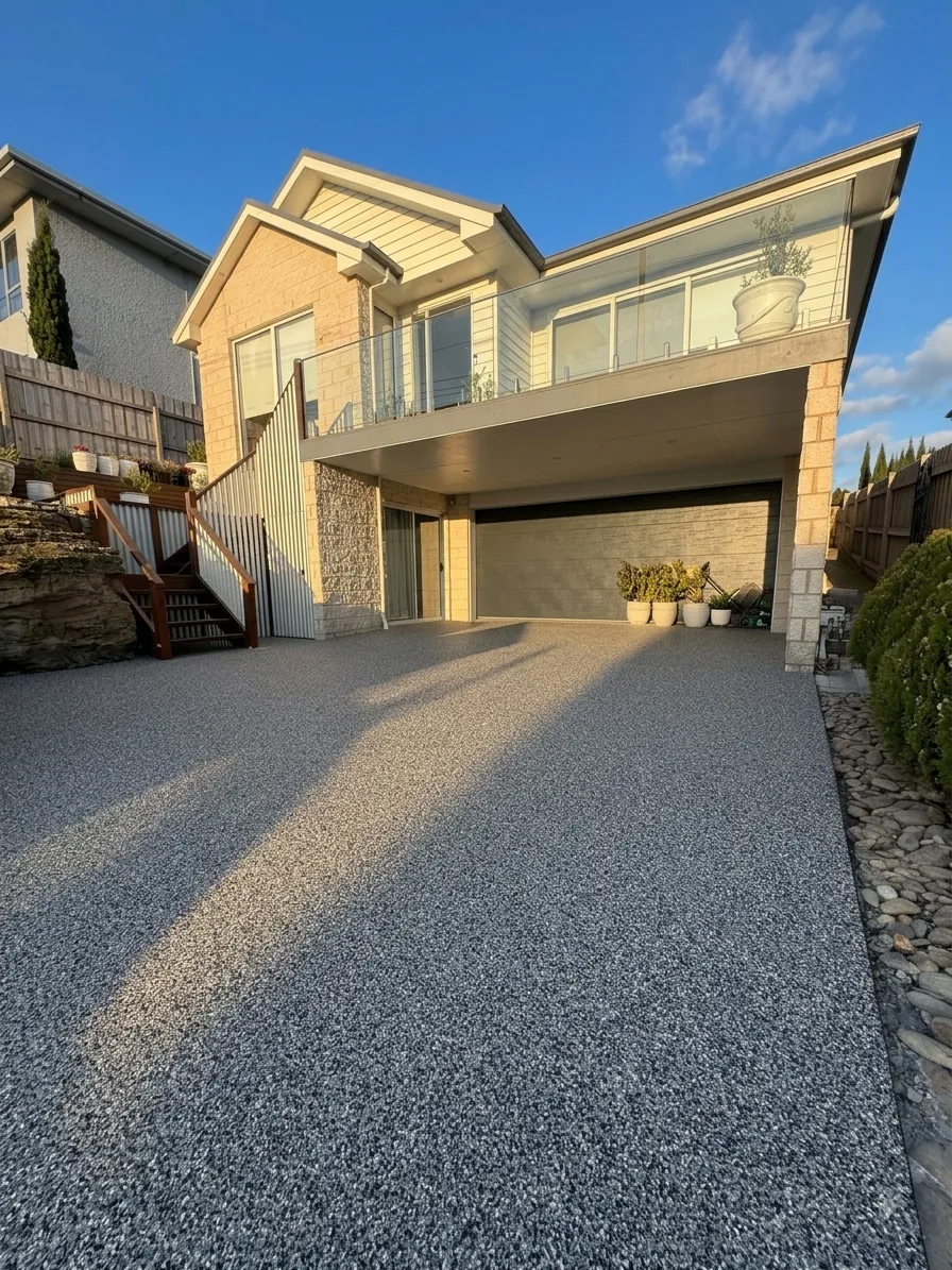 Completed resin-bound stone driveway beneath a two-storey home